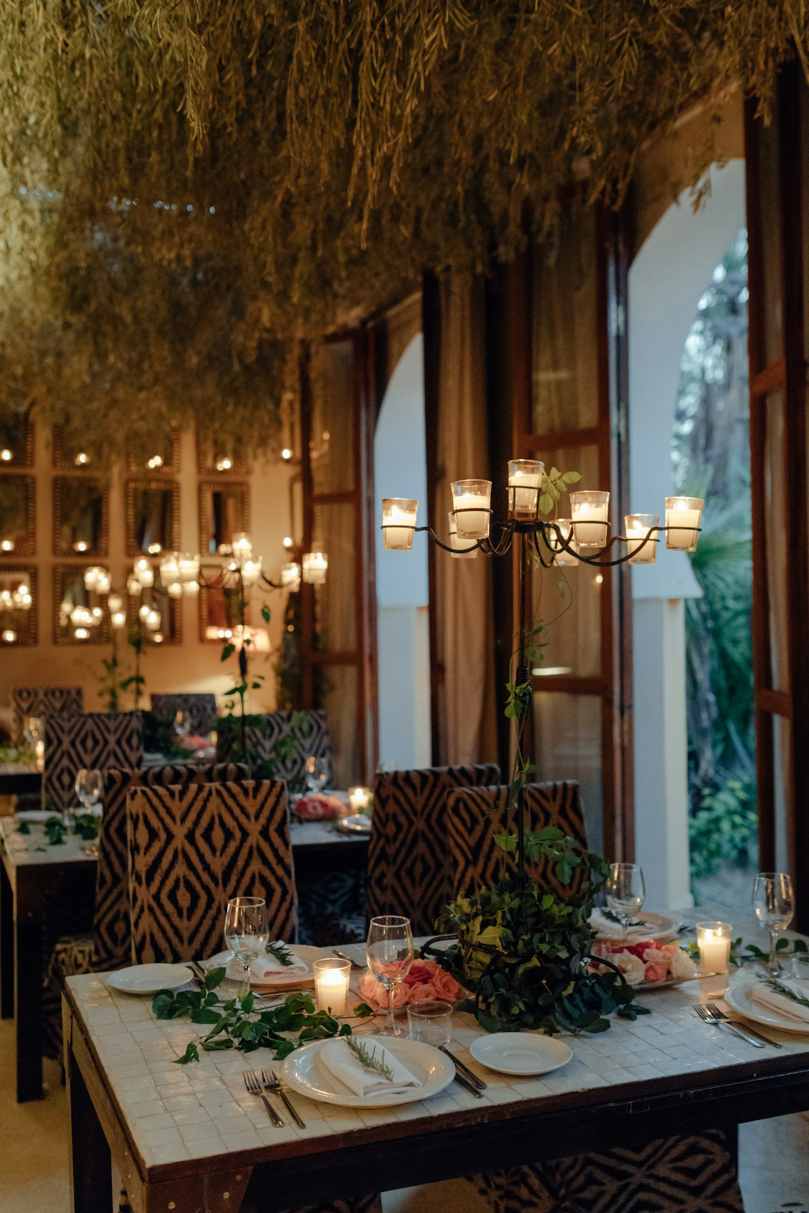 A candlelit table set for dinner at a resort restaurant